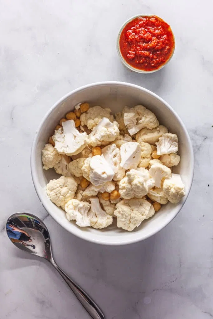 Harissa Roasted Cauliflower and Chickpeas with Tahini Sauce 