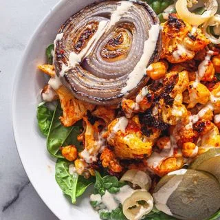 Harissa Roasted Cauliflower and Chickpeas with Tahini Sauce